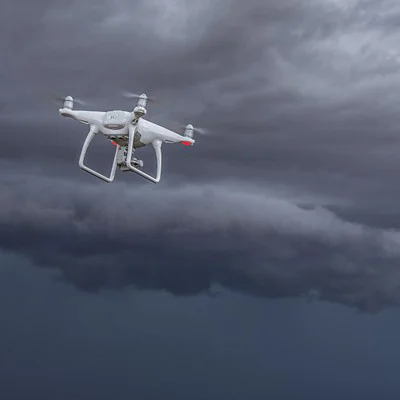 drone flying over grey clouds