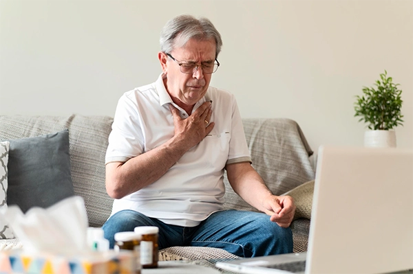 man having a heart attack at home