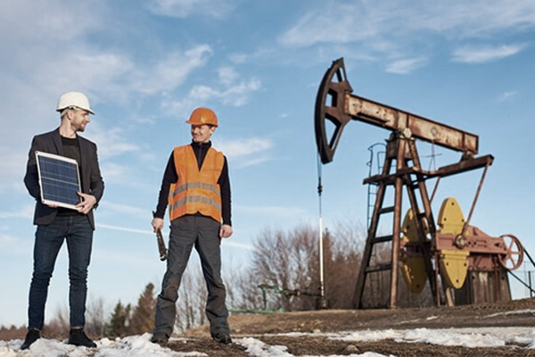 photo of two men working on oil platform